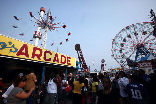 NEW YORK - MAY 29: People gather on opening day of the new Luna Park amusement area (L) at Coney Island on the first day of the Memorial Day weekend May 29, 2010 in the Brooklyn borough of New York City. Luna Park opens today on the former grounds of the famed Astroland amusement area as part of the revitalization plans for Coney Island. (Photo by Mario Tama/Getty Images)