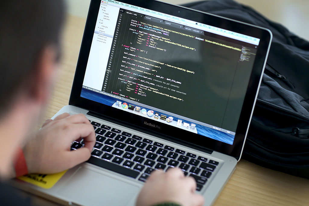 A computer screen is filled with code as Dan Vera writes a program