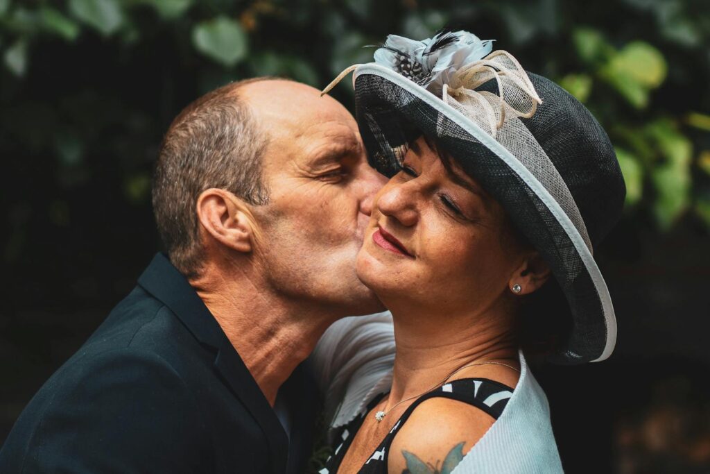 Happy couple sharing a tender moment in a lush garden, capturing the essence of love and togetherness.