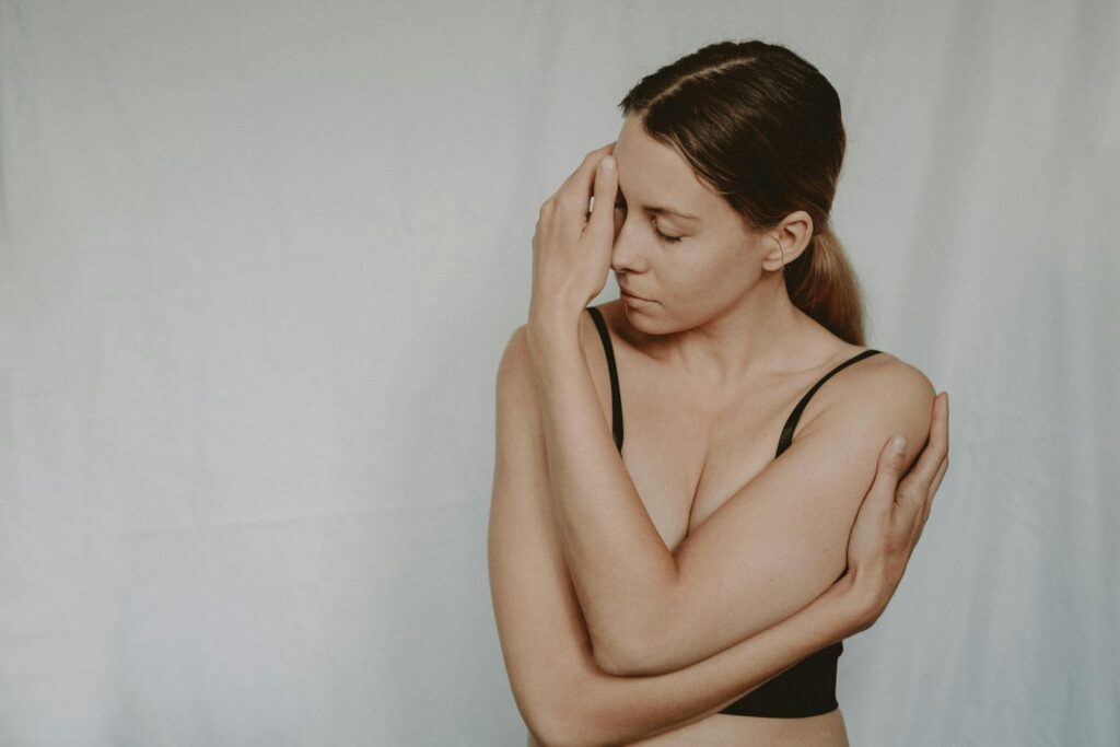 A woman with closed eyes expressing emotion and introspection indoors.