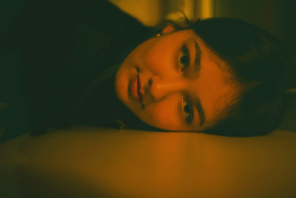 a woman laying on the floor with her eyes closed