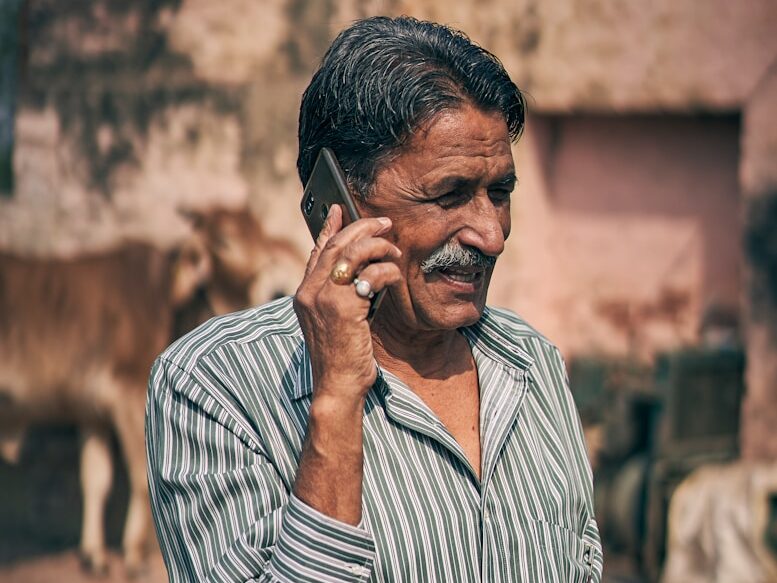 selective focus photography of man holding smartphone