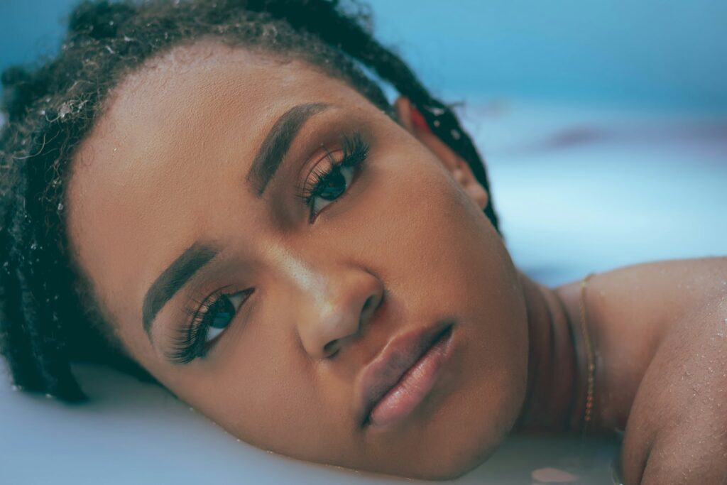 a close up of a person laying on a bed