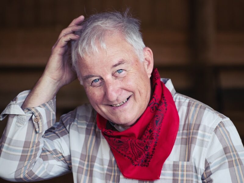 man in white and black plaid dress shirt wearing red scarf