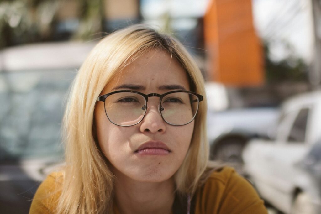 a woman with glasses looking at the camera