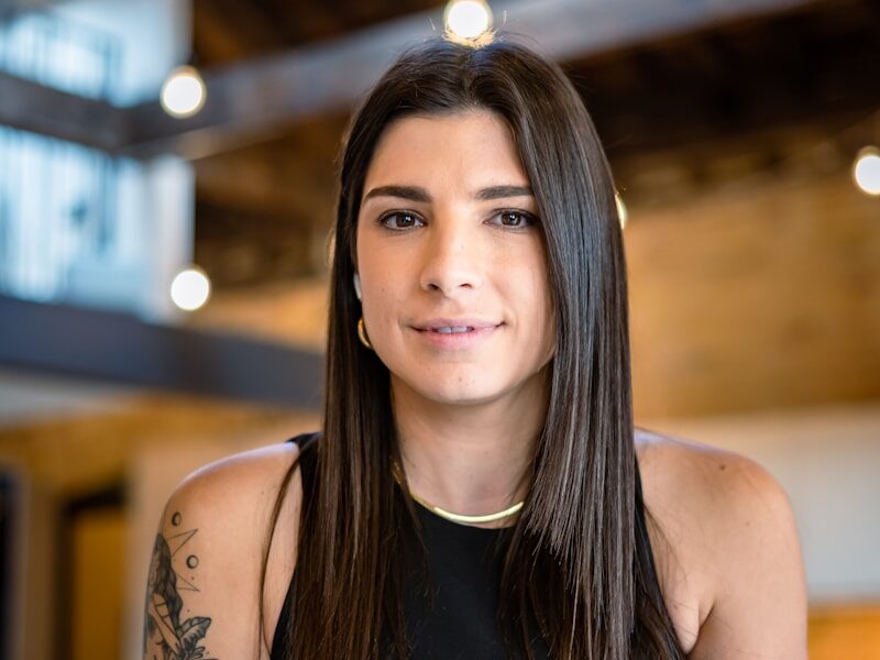 a woman in a black top is sitting down