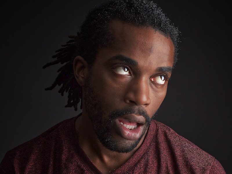 man opening his mouth and looking up