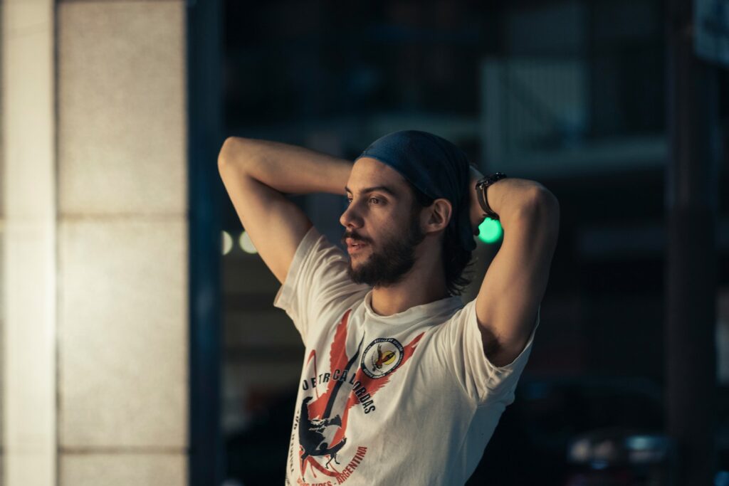 man in white crew neck t-shirt wearing blue cap