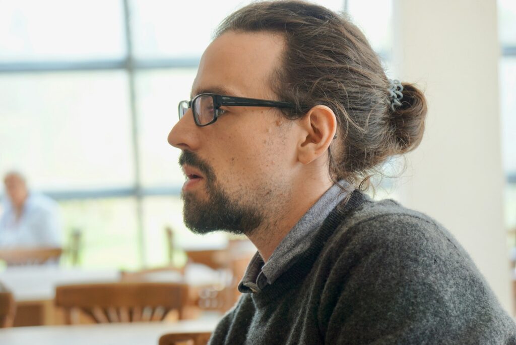 man in black framed eyeglasses and gray hoodie
