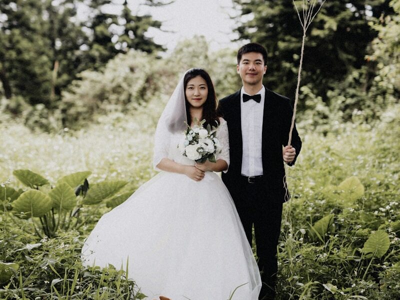 newly wed couple walking on the grass field