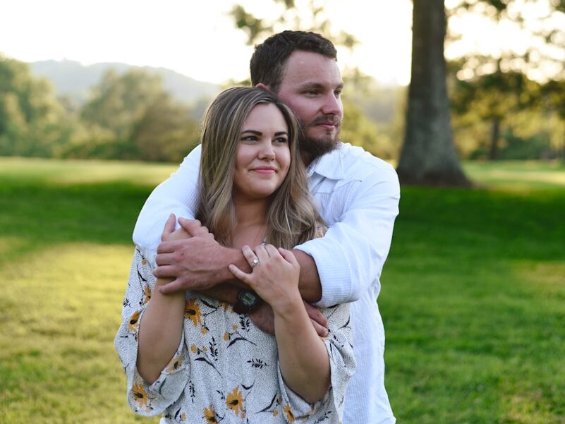 man and woman at a green field