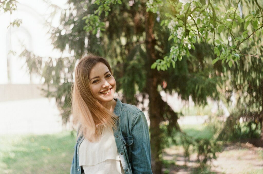 woman in blue denim jacket smiling