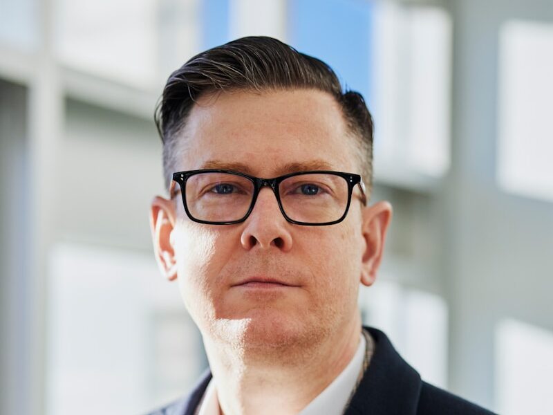 man standing beside wall