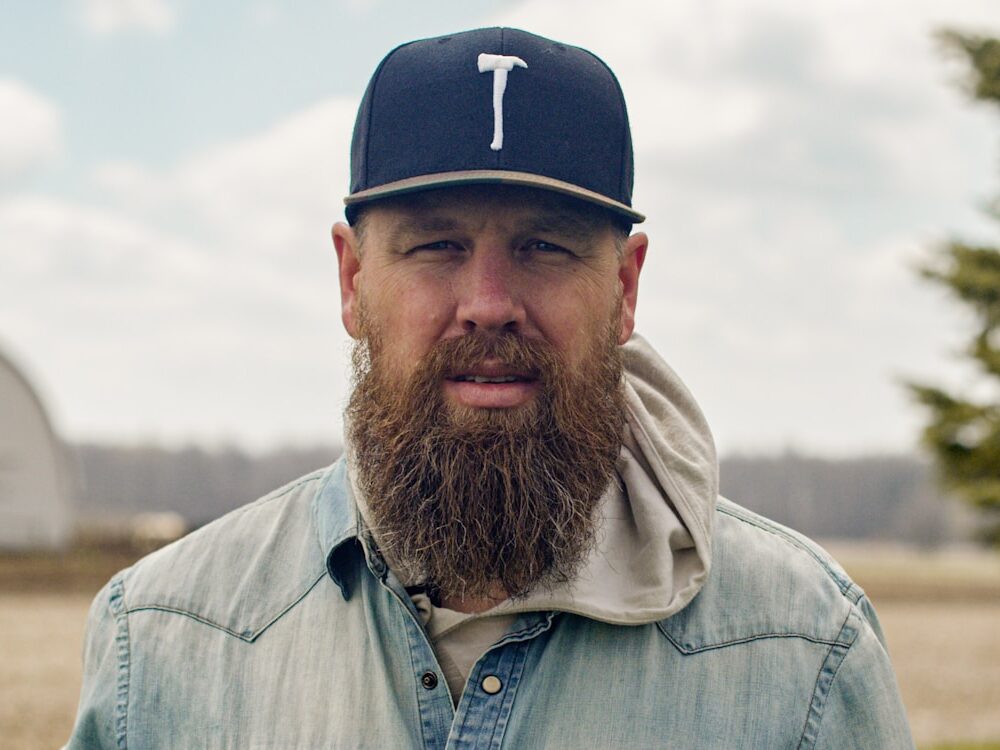 a man with a long beard wearing a hat