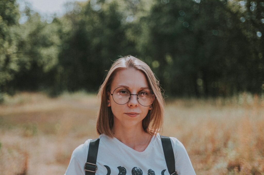 woman in white and black adidas crew neck shirt wearing brown framed eyeglasses