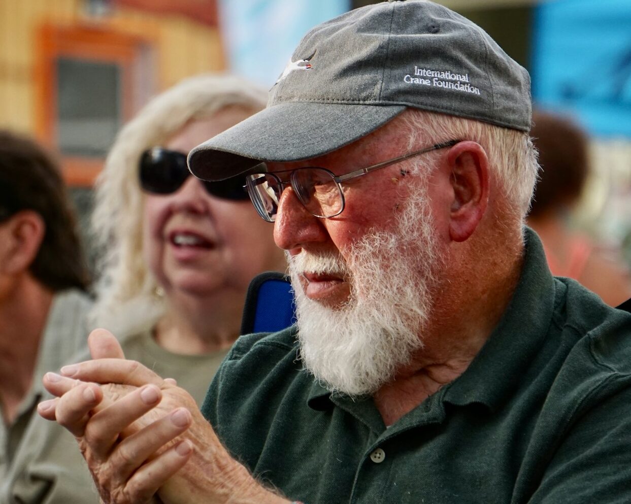 man in black jacket wearing black sunglasses and gray cap