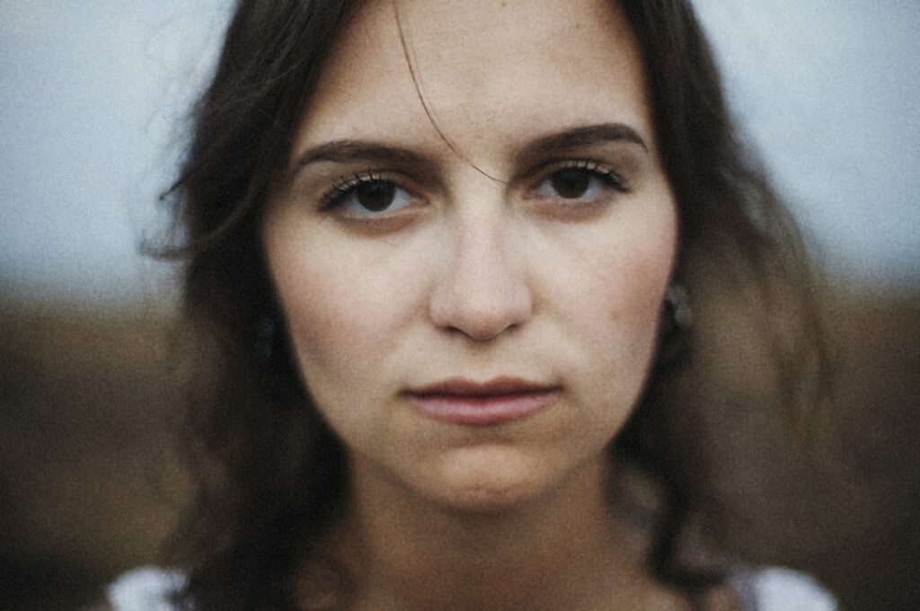 woman in white shirt taking selfie