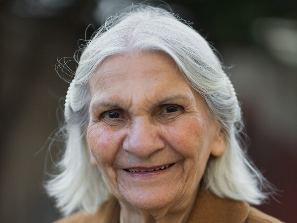 an older woman with white hair and a smile
