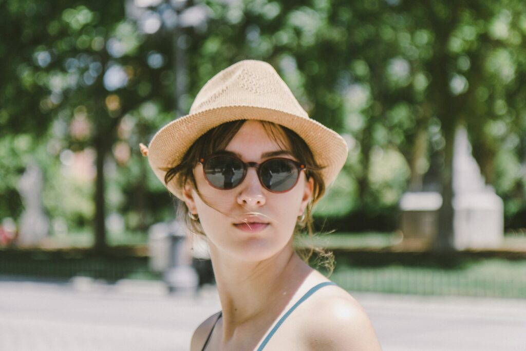 a woman wearing a hat and sunglasses