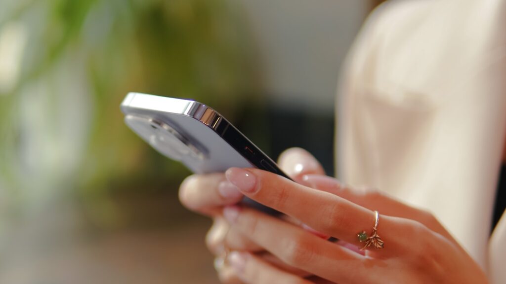 a close up of a person holding a cell phone