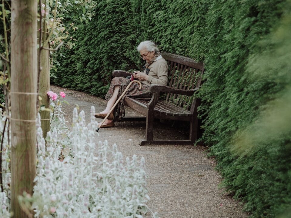 woman sitting on brown bench
