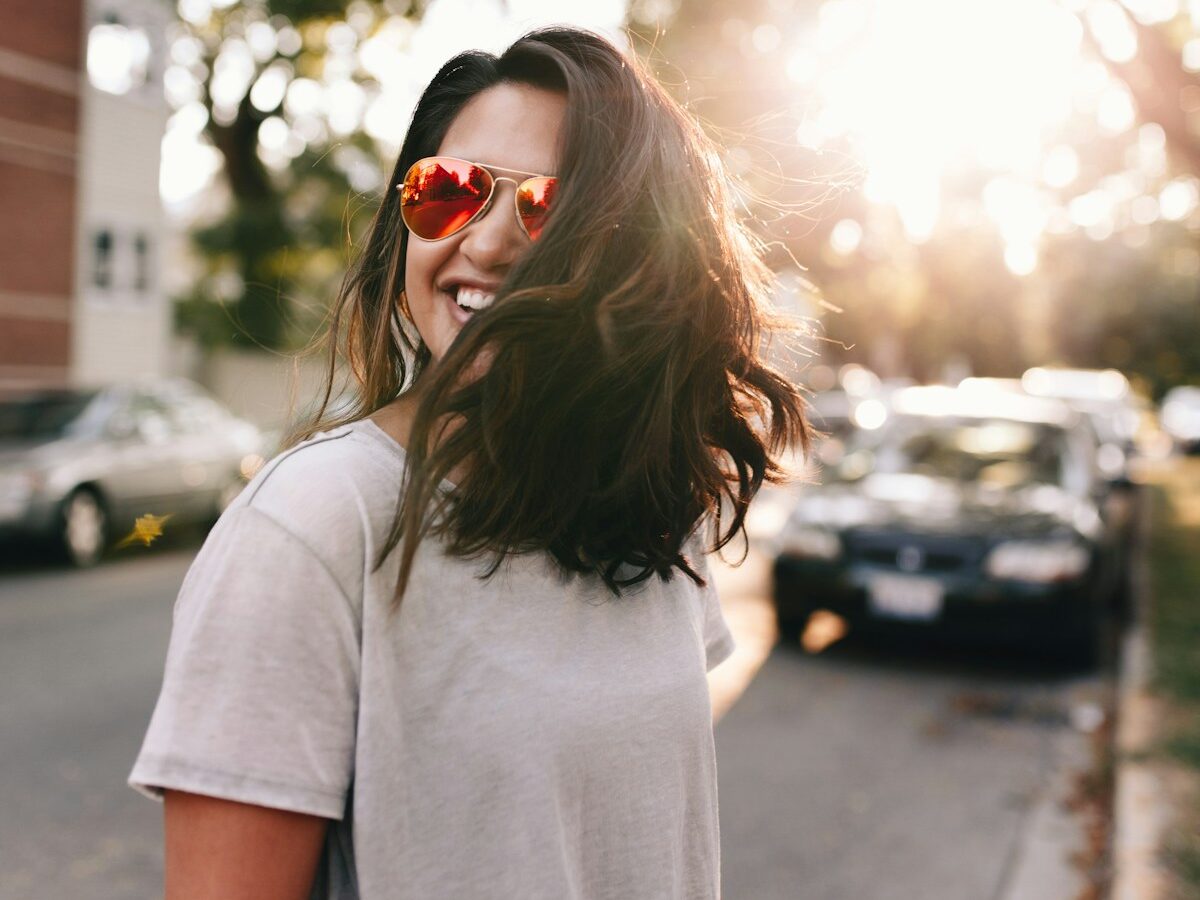 woman wearing white T-shirt smiling