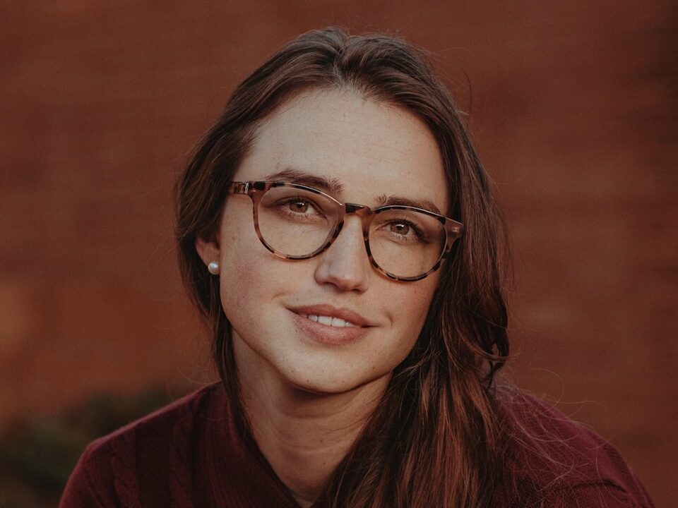 a person with long hair and glasses