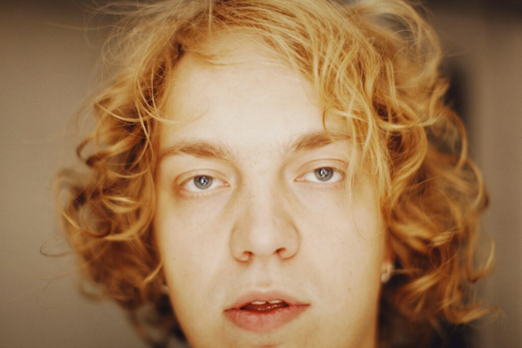 a close up of a person with curly hair