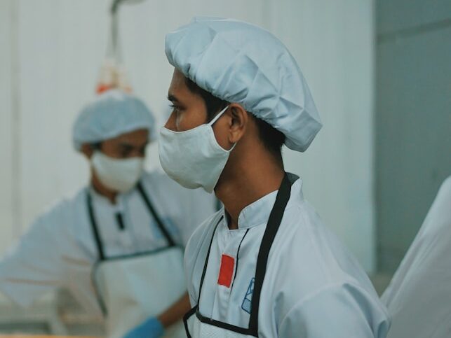 man in white medical scrub wearing white face mask