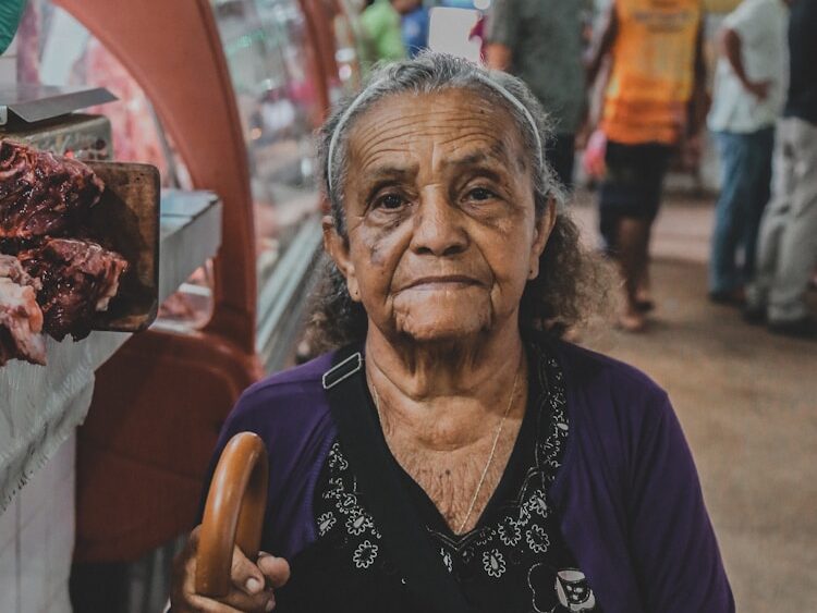 woman standing near glass while looking camera