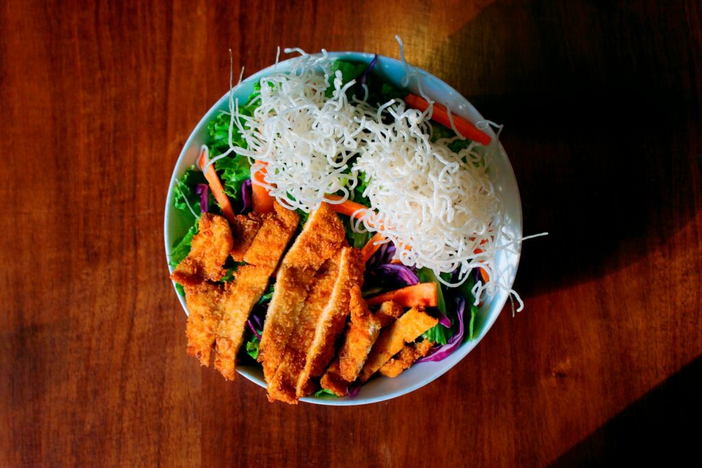 fried food on green and white ceramic bowl