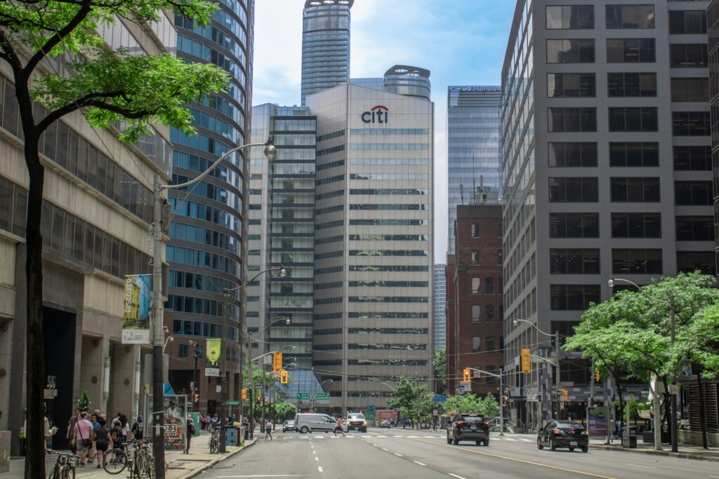a city street with tall buildings in the background