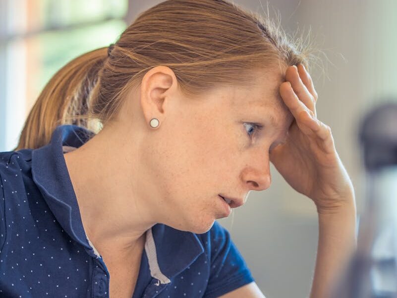Businesswoman showing stress and concentration while working at her desk.