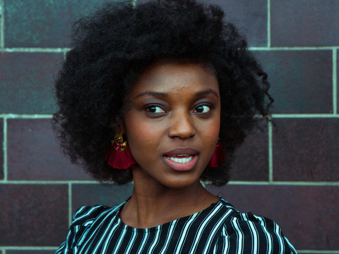 woman wearing black and green top