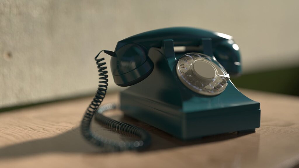 Close-up of a vintage rotary telephone with classic design, evoking nostalgia.