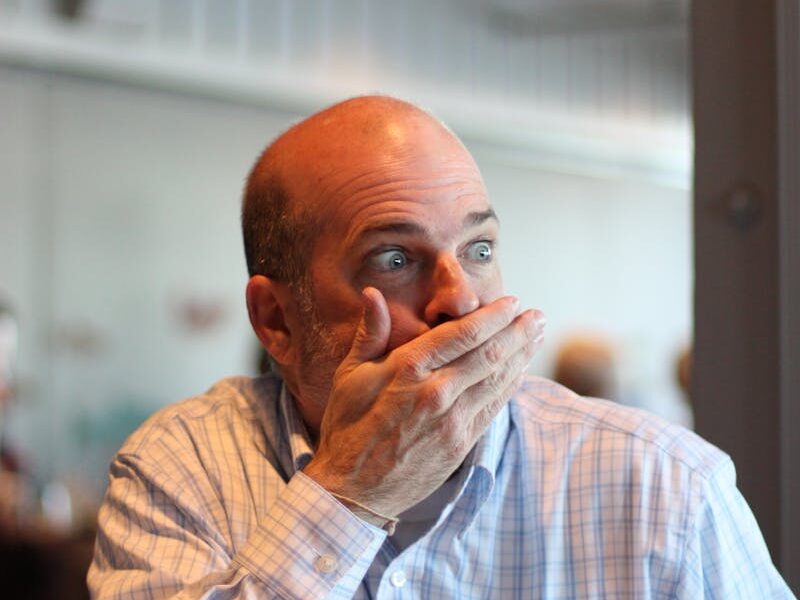 A man looking shocked indoors in Seattle, capturing a moment of surprise.