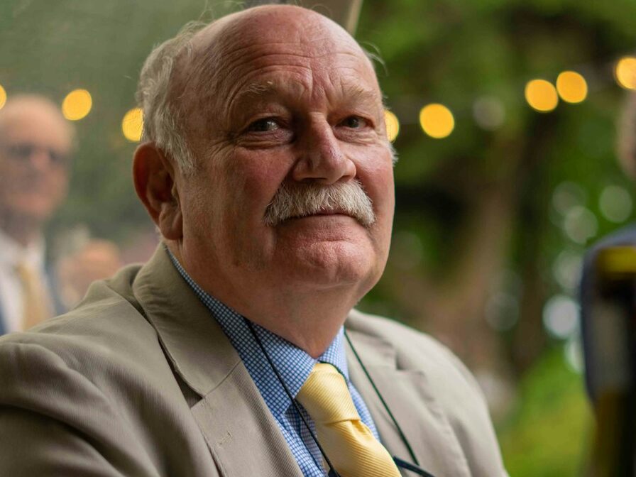 man in gray suit jacket sitting on chair
