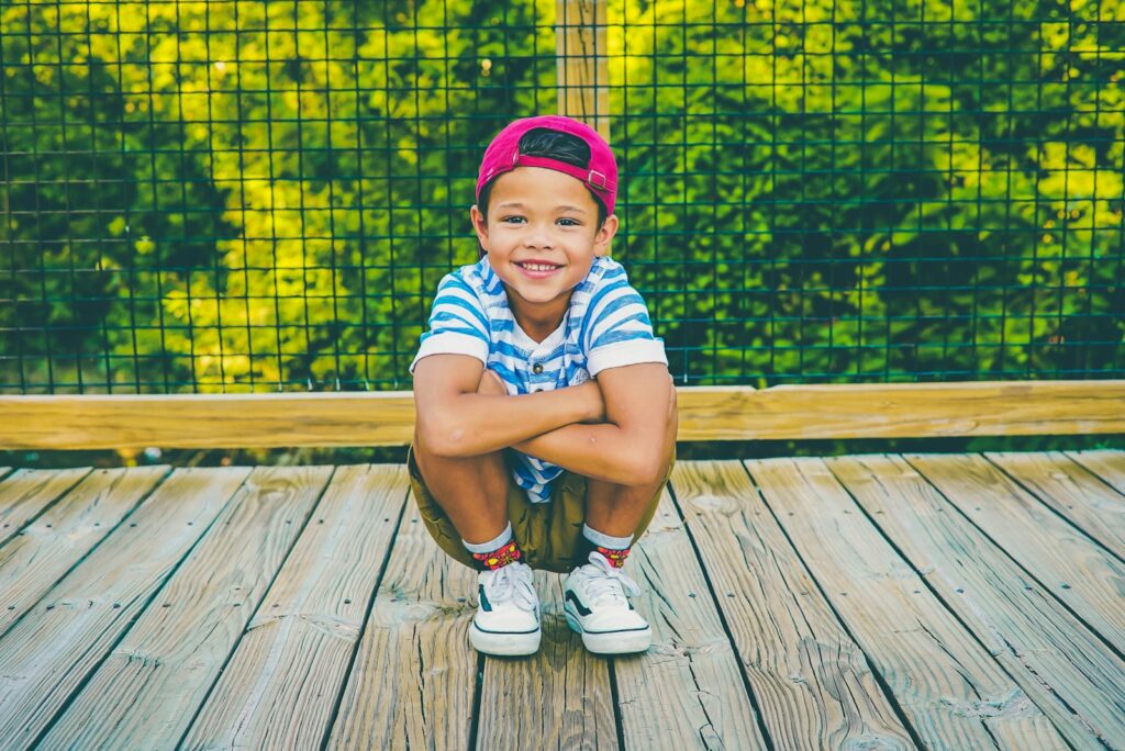 boy on wooden porch near railing