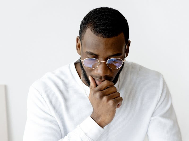 Businessman in an office setting reviews documents, indicative of focus and professionalism.