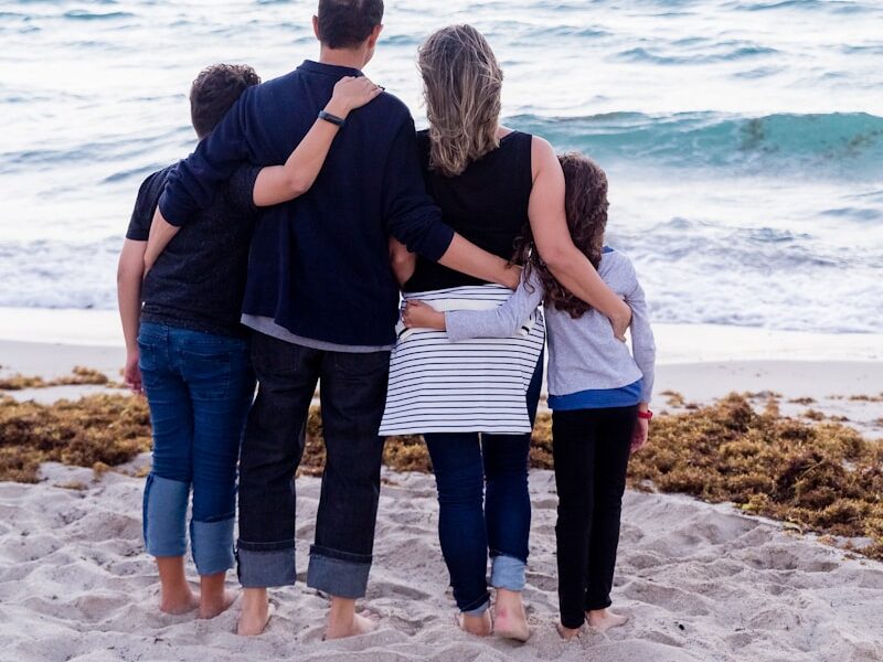 a family of four on a beach
