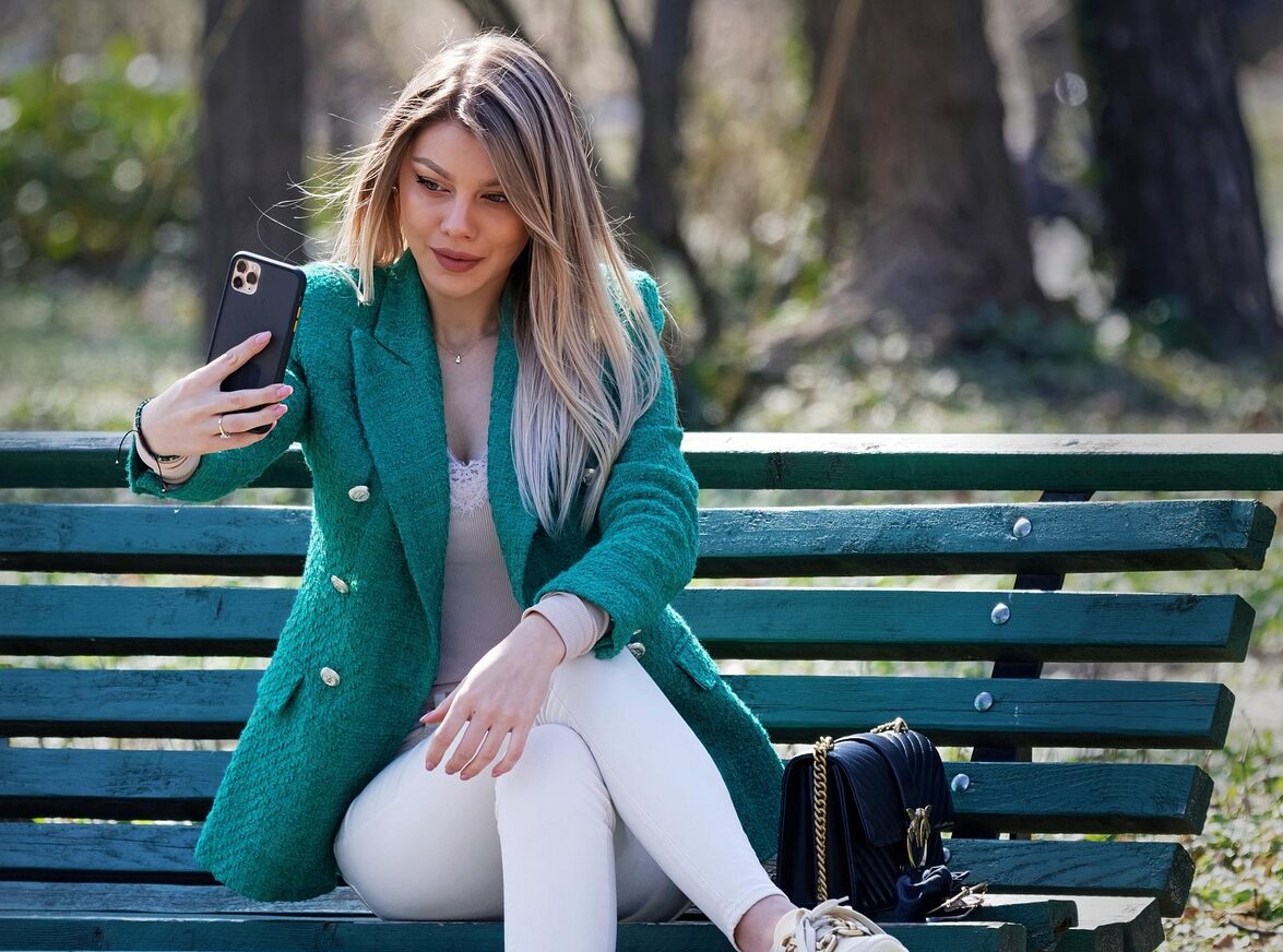 woman, bench, young, sitting, outdoors, park, taking selfie, smartphone, lifestyle