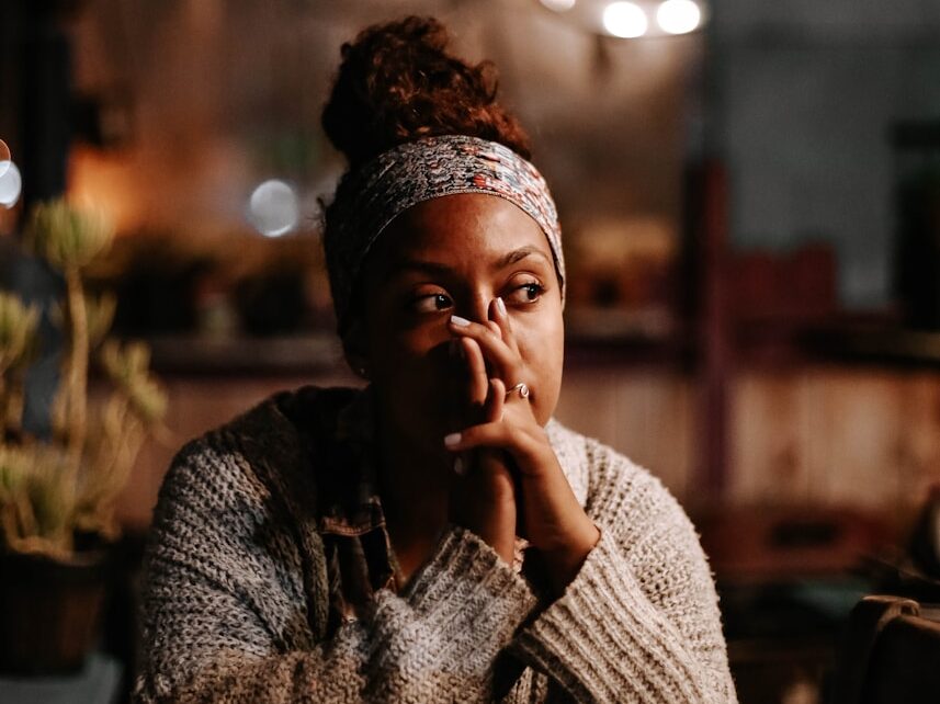man in black and white sweater sitting on chair