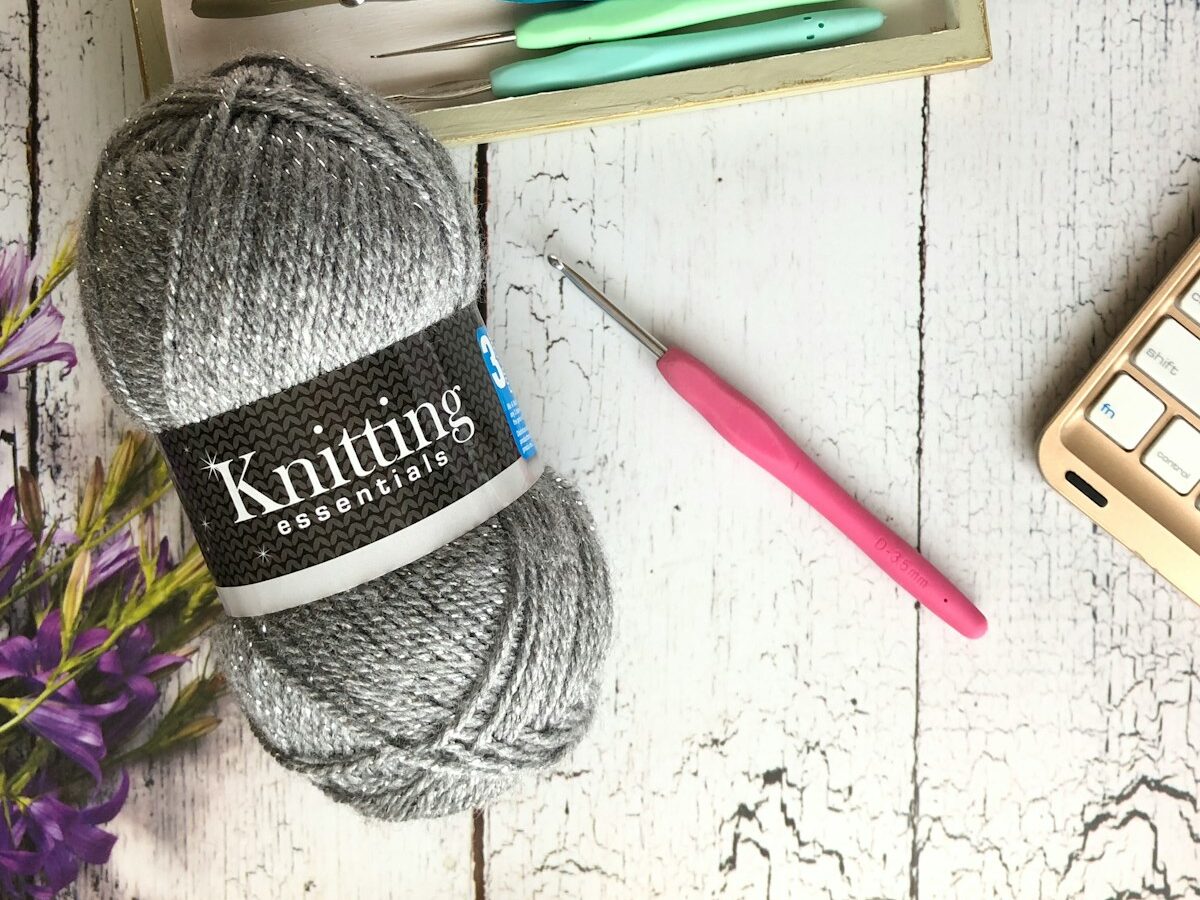 blue and white yarn ball beside pink pen