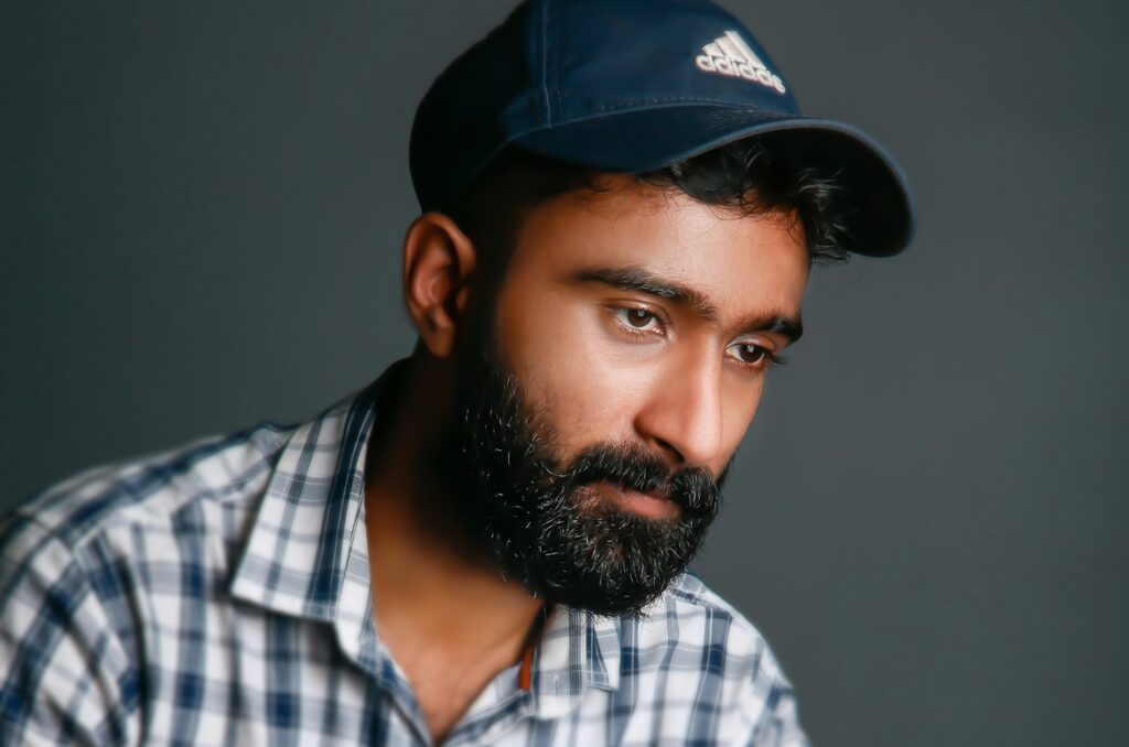 man in white blue and brown plaid button up shirt wearing black cap