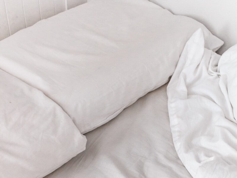 white textile on white bed