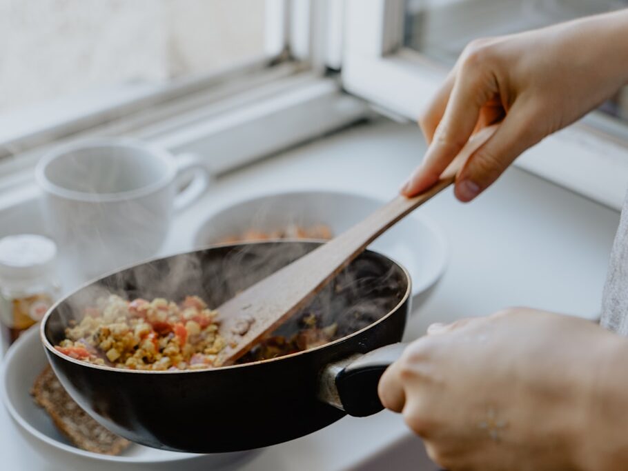 person holding black frying pan
