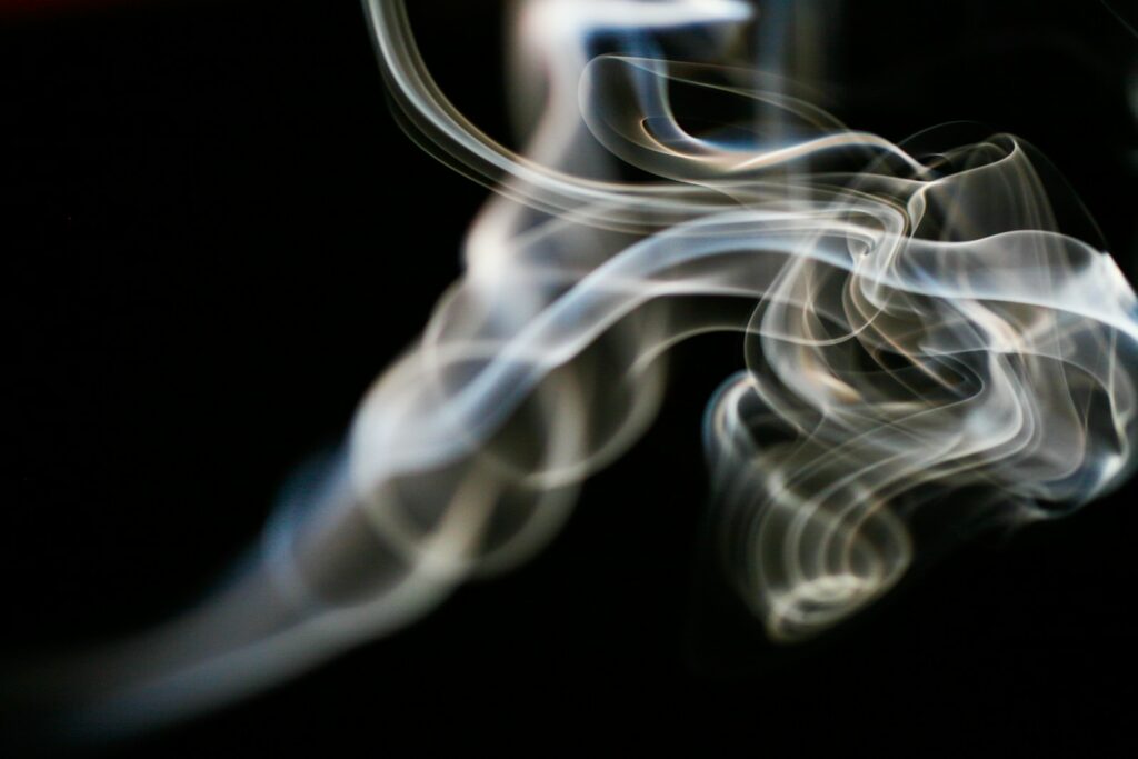 a blurry photo of smoke on a black background