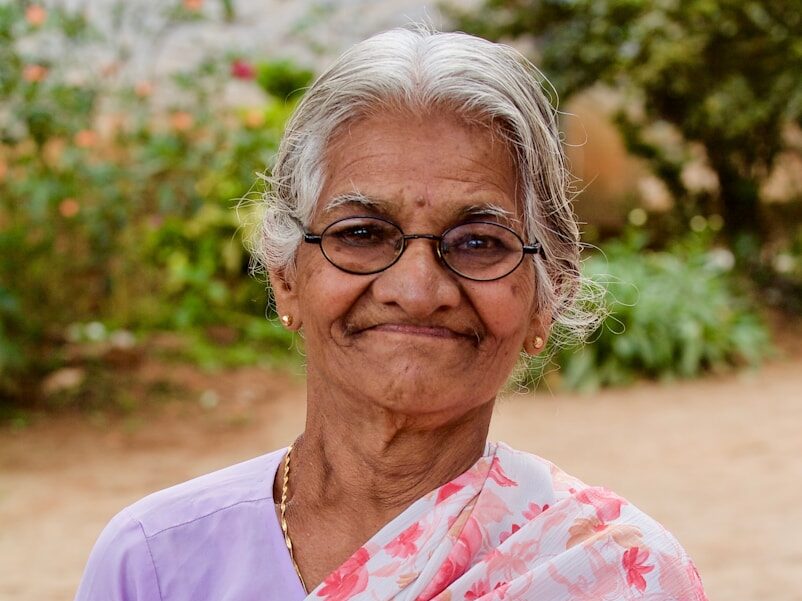 woman with floral dupatta scarf hold black leather cover book