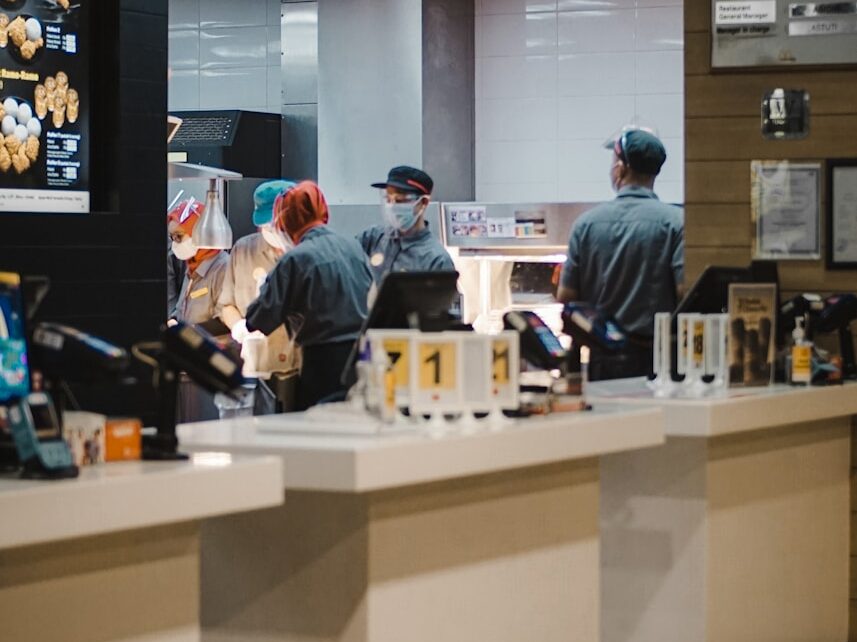 man in blue long sleeve shirt standing beside man in gray long sleeve shirt