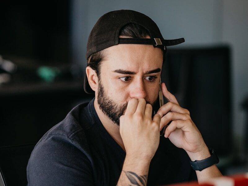 a man with a hat and tattoos